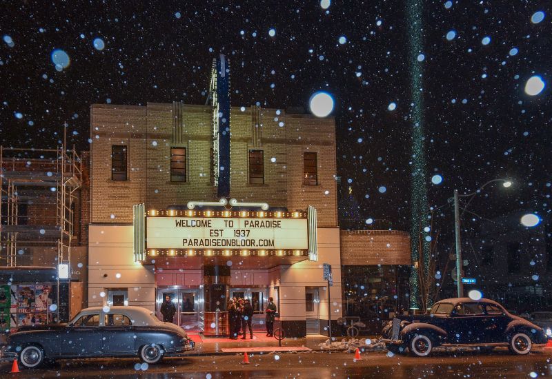 Paradise theatre exterior with vintage cars in front and the marquee reading: Welcome to Paradise est. 1937 paradiseonbloor.com